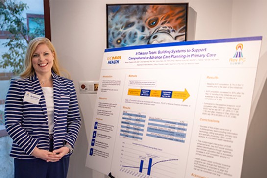 Brittany Chatterton standing next to poster